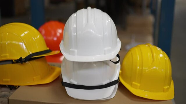 Close up of the safety hard hats in white, yellow, and orange colors