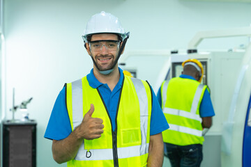 caucasian Industry Engineers on the control panel of machine CNC. wear safety uniform standing on control operating machine work in industry factory. Metalworking milling machine.
