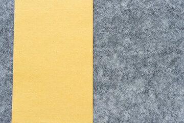 Fototapeta premium pale yellow paper and gray felt background 