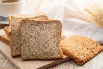 Sliced whole wheat bread on wooden cutting board,healthy food concept