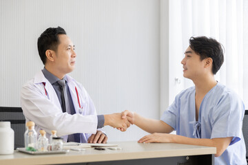 Fototapeta premium Professional doctor interacting consulting with young male patient at clinic, Male patient get advice about medicine from doctor at hospital