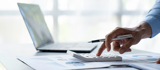 crop shot of image young man hand calculating monthly expenses finance and investment, accounting,...