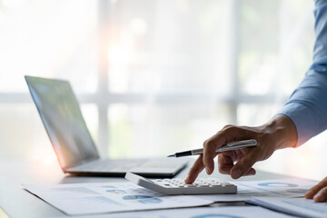 crop shot of image young man hand calculating monthly expenses finance and investment, accounting, calculating taxes, the corporate financial report of a company