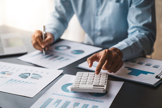 crop shot of image young man hand calculating monthly expenses finance and investment, accounting, calculating taxes, the corporate financial report of a company