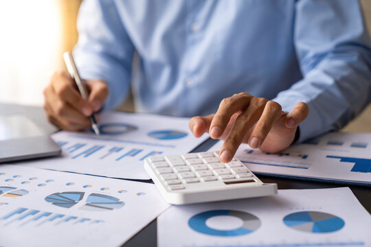 crop shot of image young man hand calculating monthly expenses finance and investment, accounting, calculating taxes, the corporate financial report of a company