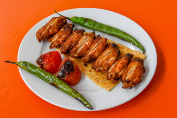 Chicken wings barbeque in a dish with BBQ grill sauce . Izgara tavuk kelebek sis kanat. Tavuk sis, gogus.