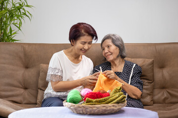 Elderly woman and daughter knitting together for protect dementia and memory loss.