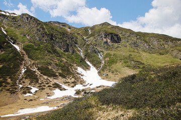Fototapeta na wymiar Waterfalls on the way to mountain water reservoirs in Kaprun, Austria 
