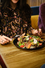 close-up, woman's hands, eating meat salad