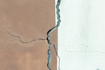 Obraz premium Texture background abstract. Old concrete or Cement brown and white fence broken, seeing structure is steel rust inside. Damaged non-standard building. Dangerous unsafe construction. Safety concept.