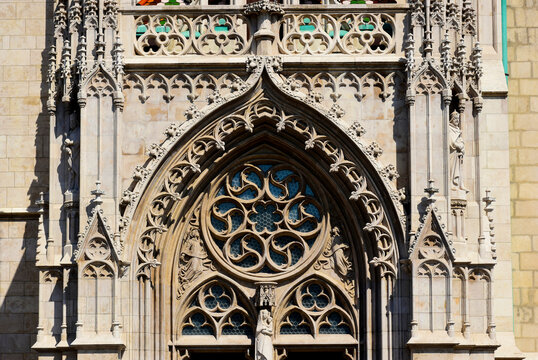 Beautiful ornate stone rose window of the Matthias church in Budapest, Hungary. fine beige stone lace work in neo gothic style. rich ornate sculpted arch and balustrade. travel and tourism concept.