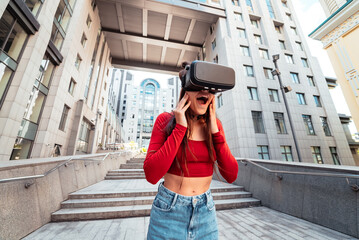 Woman in a virtual reality helmet walks down the street