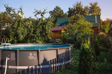 Swimming pool with metal frame for home and garden. Frame swimming pool in the yard. Solar...