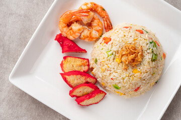 Yangzhou fried rice is a popular Chinese-style wok fried rice dish. Asia Chinese China food cuisine. Authentic Yangzhou fried rice with egg, fresh prawn and Red Roast Pork.