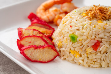 Yangzhou fried rice is a popular Chinese-style wok fried rice dish. Asia Chinese China food cuisine. Authentic Yangzhou fried rice with egg, fresh prawn and Red Roast Pork.
