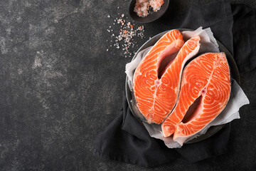 Salmon. Raw salmon steak. Fresh raw salmon fish with cooking ingredients, herbs and lemon prepared...