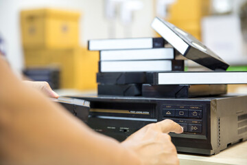 Close-up hand press button on video record playback concept of vintage electric and electronic appliances multimedia player device old fashioned.