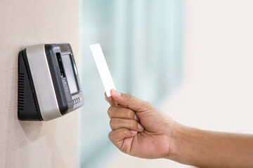 Proximity card reader door unlock, Hand security man using ID card on fingerprint scanning access control system for identity verification to open the door or for security safety or check attendance.