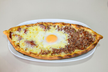 Kiymali pide. Turkish pide with minced meat. Turkish pizza mince pita Pide on white background. Etli ekmek. Kusbasi kasarli pide.