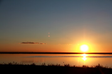 Fototapeta na wymiar Sunset on the calm water of tha saline