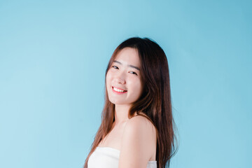 Charming portrait of Asian woman smiling confidence beauty make up on the blue background