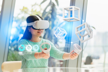 smart attractive asian female business owner weared virtual reality augmented reality glasses enjoys casual metaverse meeting with concentrate at cafe,asian female wear headset goggle gear in cafe