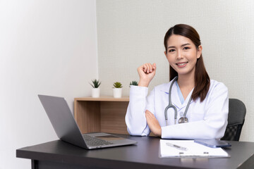 Asian female doctor wearing white medical uniform He hung a heart rate monitor around his neck. happy smile With confidence isolated against background