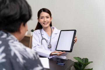 A beautiful Asian doctor discusses the condition of a male patient being hospitalized Check  results  in tablet