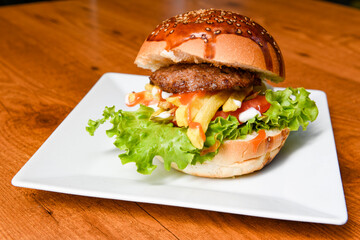 Big tasty burger with beef cutlet on a plate. Crispy chicken burger.