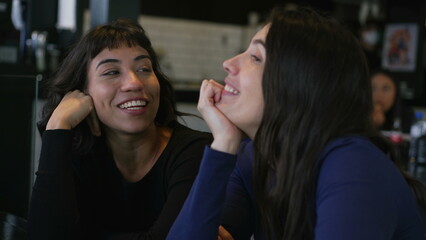 Happy women in conversation at cafe restaurant. Two people talking casually