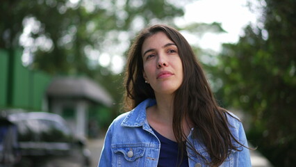 One thoughtful woman walking outside thinking. Closeup person face walks forward in contemplation