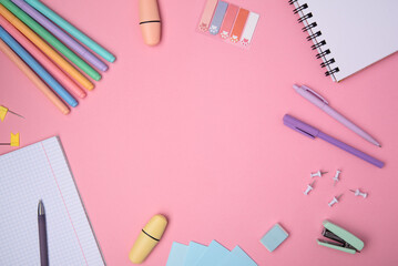 The concept of Back to school. School stationery on a pink background, background