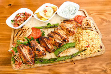 A skewered chicken kebob with grilled onions, bell peppers and delicious white meat with seasoning isolated on a white background. Tavuk sis, Tavuk izgara.