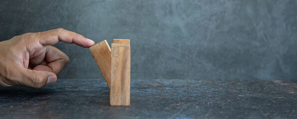 Hand prevent wooden block tower stack crash or fall domino. concept of prevention of financial...