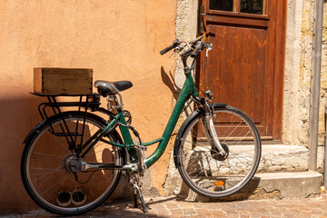 Fototapeta na wymiar Bicycle parked by the door of a house in Annecy, France