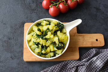 Boiled potatoes with spinach, garlic, and olive oil