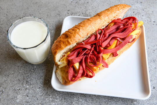 Close-up shot of Izmir's famous Turkish Traditional Kumru Sandwich, &Ccedil;eşme Kumru, Karisik sandvic,  ingredients ready to eat salami, soudjouk, tomato, cheddar cheese and fried cheese. Yengen sandvic.