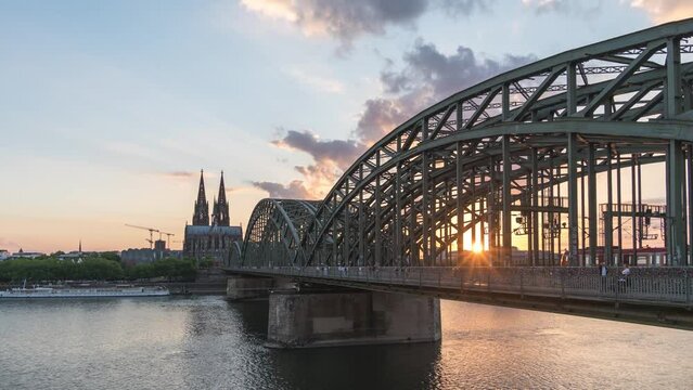 Cologne (Köln) Germany time lapse 4K, city skyline sunset timelapse at Cologne Cathedral (Cologne Dom) with Rhine River and Hohenzollern Bridge