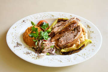 Beef steak grill with rice pilaf, fried potatoes, grilled pepper and tomatoes.Mix Platter with Beef rips, Cutlets, Potatoes and Sauces.