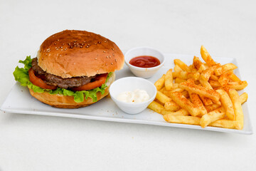 Big tasty  burger with beef cutlet on a plate. Hamburger.