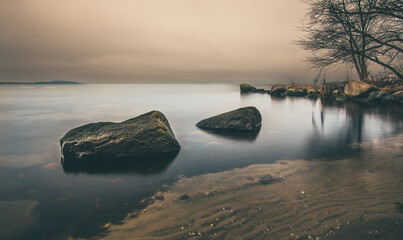 View of a bay at the German Baltic Sea coast with big rocks in the foreground