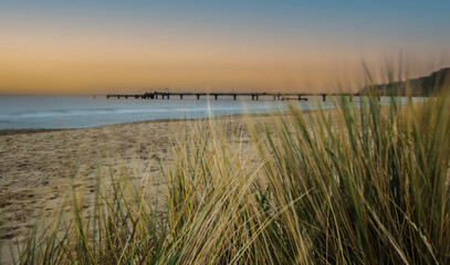 Pier on the German Baltic Sea coast on the island of R&uuml;gen with reeds in the foreground