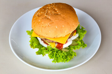 Big tasty  burger with beef cutlet on a plate. Hamburger.