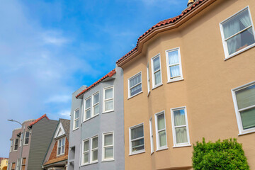Fototapeta na wymiar Row of townhouses and single-family home in a low angle view in San Francisco, California