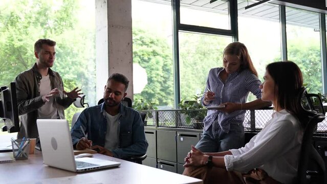 Group of millennial male and female creative occupation casual conversation meeting with cheerful and smiling,office friend standing discussion together in office