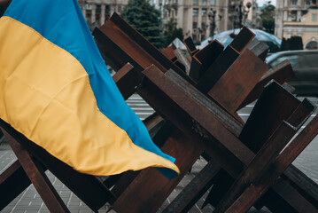 The Ukrainian flag hangs on barricades in the city