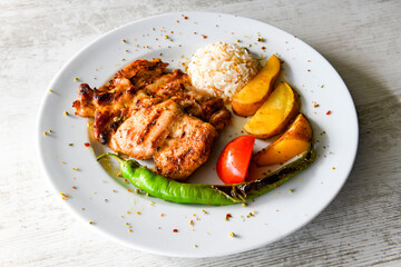 A skewered chicken kebob with grilled onions, bell peppers and delicious white meat with seasoning isolated on a white background. Tavuk sis, Tavuk izgara.