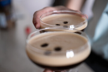 An unrecognizable couple toasting with two homemade cocktails