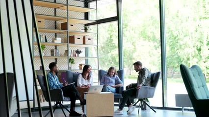 Group of business people meeting in coworking space modern office. Financial teamwork talking together in workplace