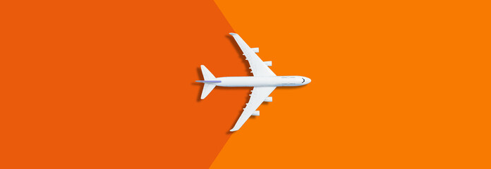 Flat lay design of travel concept with plane on yellow, orange background with copy space © Angelov